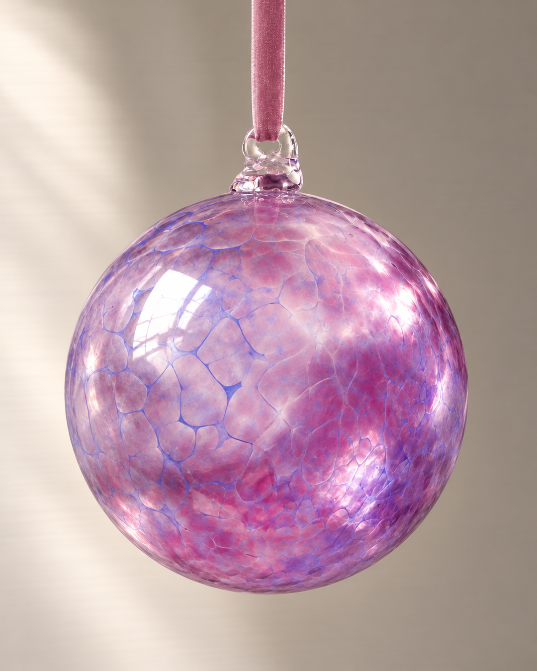 Jumbo Pink Lilac Glass Bauble hanging from a velvet ribbon