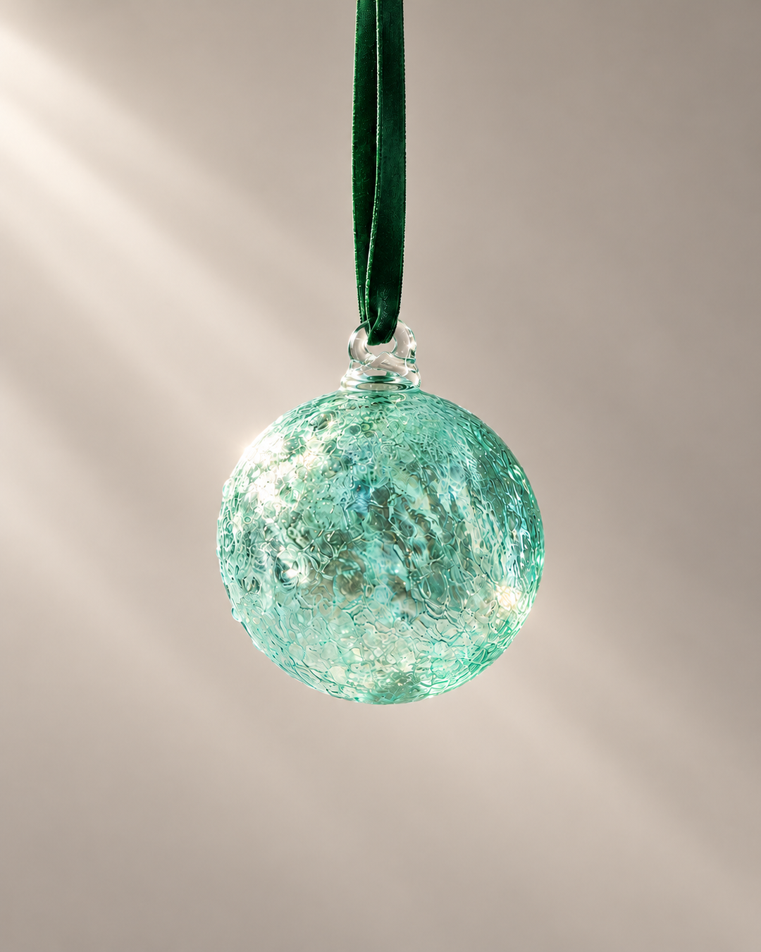 Aqua Lagoon Glass Bauble hanging from a velvet ribbon