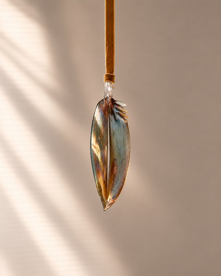 Metallic Glass Feather hanging on velvet ribbon