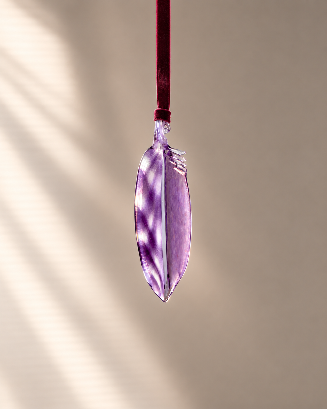 Amethyst Glass Feather hanging on velvet ribbon