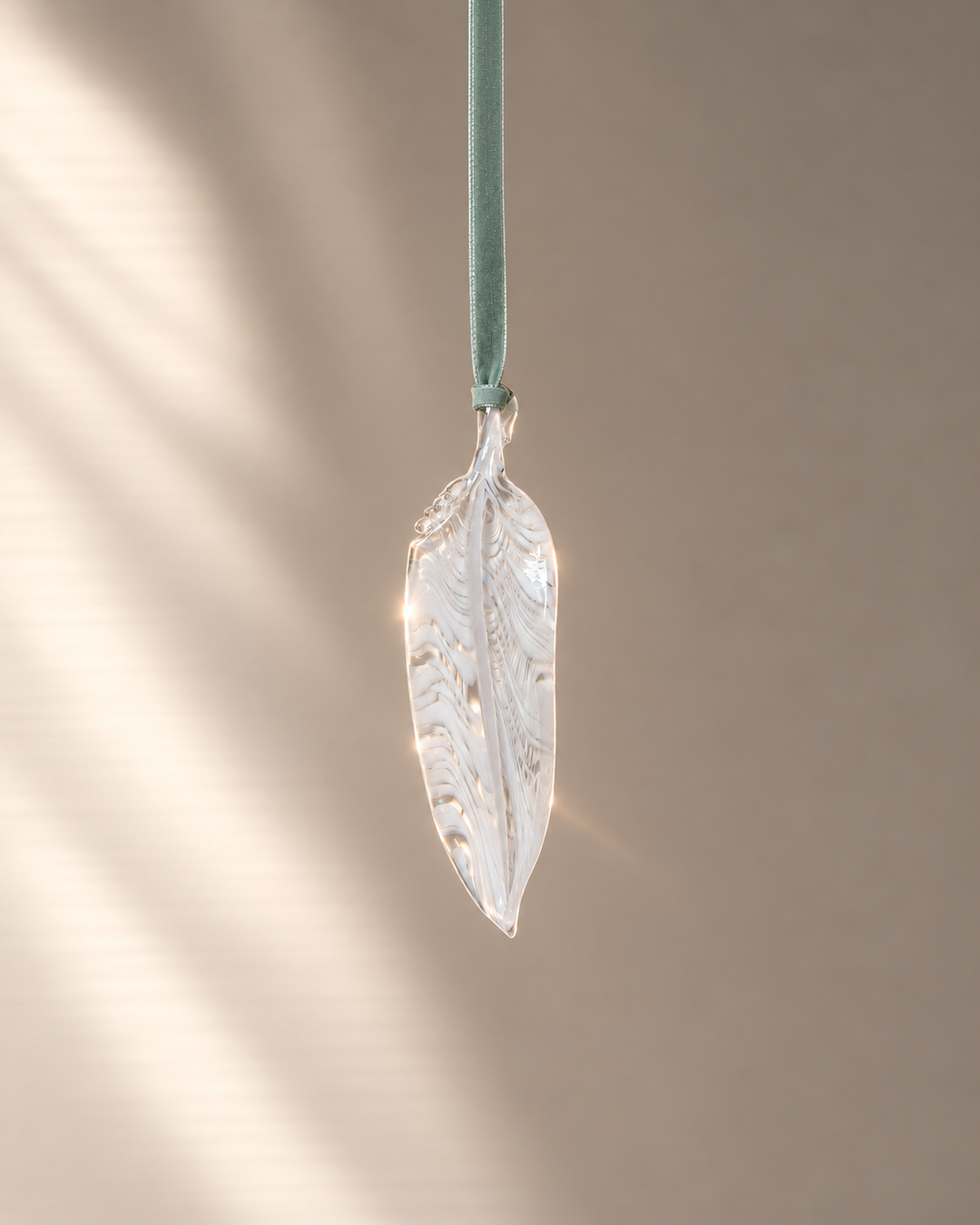 White Glass Feather hanging on velvet ribbon