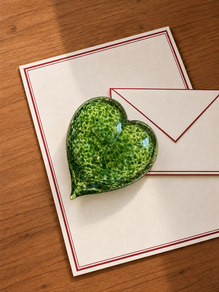Shimmering Moss Love Heart paperweight on cream letters and red-edged envelope